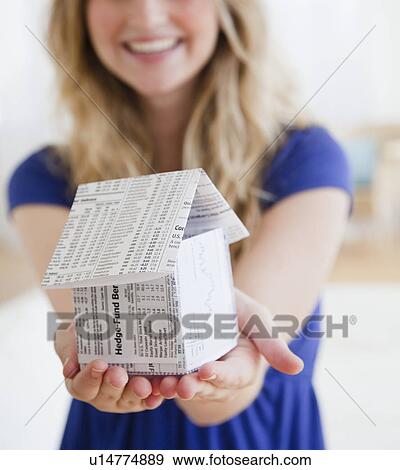 Young woman holding paper house View Large Photo Image Stock Photo - Young woman holding paper house. Fotosearch