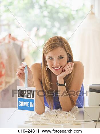 Young woman in clothes shop View Large Photo Image Stock Image - Young woman in clothes shop. Fotosearch