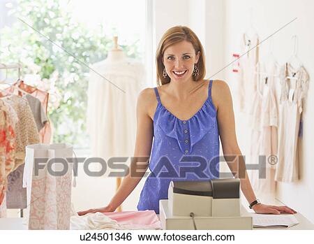 Young woman in clothes shop View Large Photo Image Stock Photograph - Young woman in clothes shop. Fotosearch