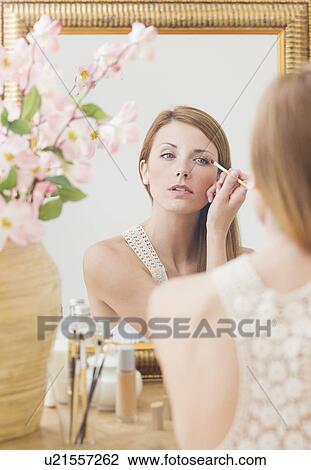 Young woman in front of mirror View Large Photo Image Stock Image - Young woman in front of mirror. Fotosearch