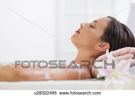 Stock Photography - Young woman taking bath. Fotosearch