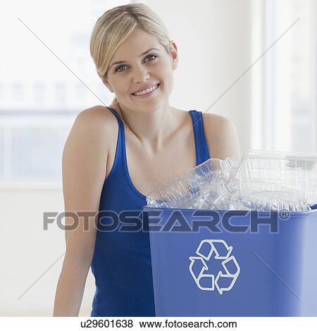 Young woman with blue recycling bin containing plastic bottles View Large Photo Image Stock Photo - Young woman with blue recycling bin containing plastic bottles. Fotosearch