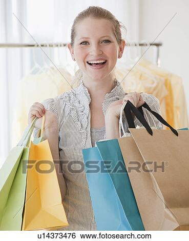 Stock Photograph - Young woman with shopping bags. Fotosearch