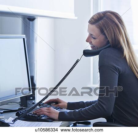 Young woman working in office View Large Photo Image Picture - Young woman working in office. Fotosearch