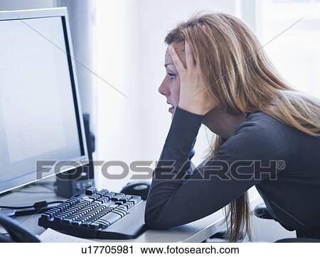 Young woman working in office View Large Photo Image Stock Image - Young woman working in office. Fotosearch