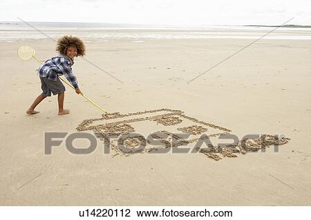 Boy drawing in sand View Large Photo Image Stock Image - Boy drawing in sand. Fotosearch