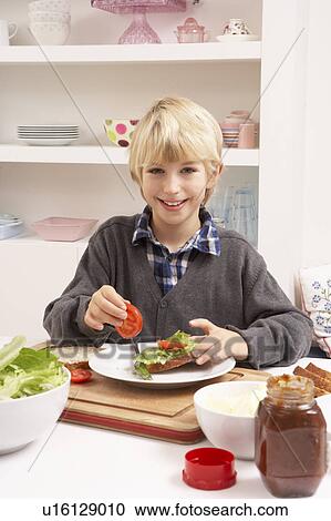 Stock Image - Boy Making Sandwich In Kitchen. Fotosearch