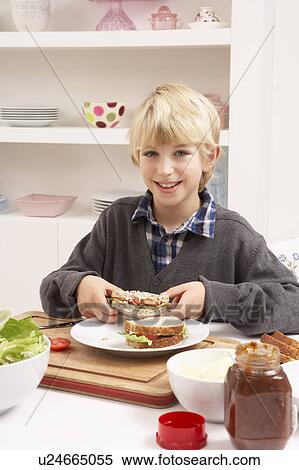 Stock Photography - Boy Making Sandwich In Kitchen. Fotosearch
