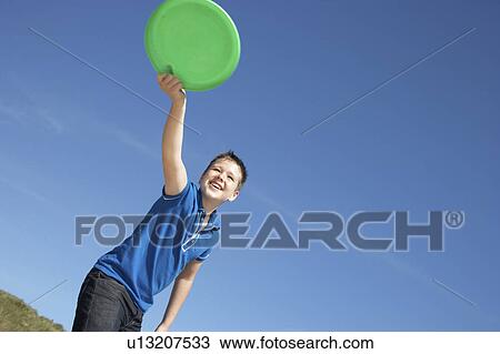 Boy playing frisbee on beach View Large Photo Image Stock Image - Boy playing frisbee on beach. Fotosearch