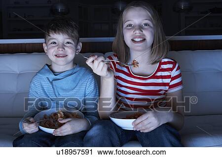 Children Enjoying Meal Whilst Watching TV View Large Photo Image Stock Image - Children Enjoying Meal Whilst Watching TV. Fotosearch