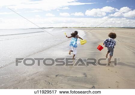 Children playing on beach View Large Photo Image Stock Photo - Children playing on beach. Fotosearch