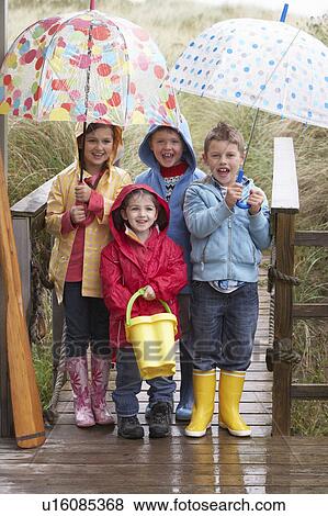 Children posing with umbrella View Large Photo Image Stock Photo - Children posing with umbrella. Fotosearch