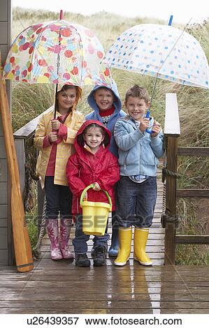 Children posing with umbrella View Large Photo Image Stock Photo - Children posing with umbrella. Fotosearch