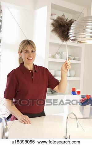 Cleaner Working In Domestic Kitchen With Feather Duster View Large Photo Image Stock Photograph - Cleaner Working In Domestic Kitchen With Feather Duster. Fotosearch