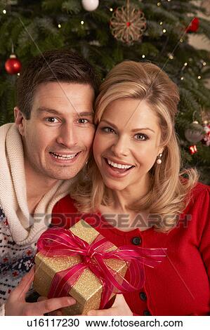 Couple Exchanging Christmas Gifts View Large Photo Image Stock Image - Couple Exchanging Christmas Gifts. Fotosearch