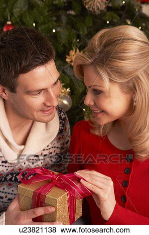 Stock Photo - Couple Exchanging Christmas Gifts. Fotosearch