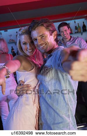 Stock Photo - Couple Having Fun In Busy Bar. Fotosearch