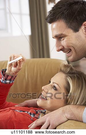 Stock Photo - Couple Looking At Result Of Home Pregnancy Test Kit. Fotosearch
