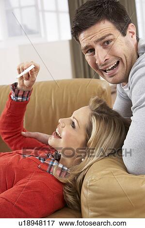 Stock Photo - Couple Looking At Result Of Home Pregnancy Test Kit. Fotosearch