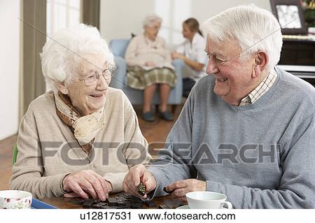 Stock Image - Couple Playing Dominoes At Day Care Centre. Fotosearch