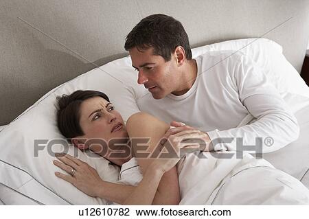 Stock Image - Couple With Problems Having Disagreement In Bed. Fotosearch