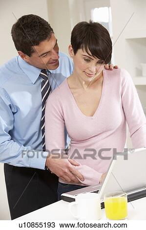 Couple Working From Home Using Laptop View Large Photo Image Stock Image - Couple Working From Home Using Laptop. Fotosearch