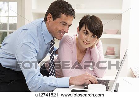 Couple Working From Home Using Laptop View Large Photo Image Stock Image - Couple Working From Home Using Laptop. Fotosearch
