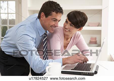 Couple Working From Home Using Laptop View Large Photo Image Stock Photo - Couple Working From Home Using Laptop. Fotosearch