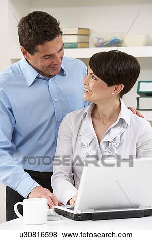Couple Working From Home Using Laptop View Large Photo Image Stock Photo - Couple Working From Home Using Laptop. Fotosearch