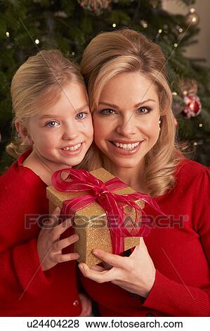 Stock Photo - Daughter Giving Mother Christmas Gift. Fotosearch