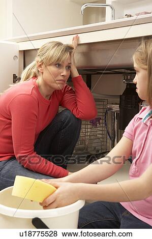 Daughter Helping Mother To Mop Up Leaking Sink View Large Photo Image Stock Photo - Daughter Helping Mother To Mop Up Leaking Sink. Fotosearch
