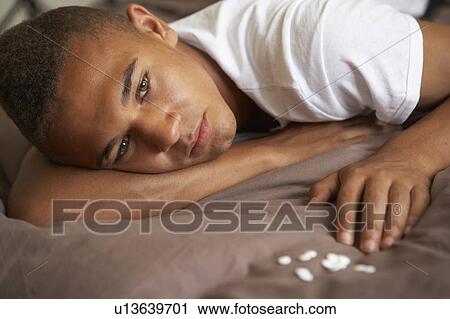 Depressed Teenage Boy Lying In Bedroom With Pills View Large Photo Image Stock Image - Depressed Teenage Boy Lying In Bedroom With Pills. Fotosearch