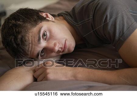 Depressed Teenage Boy Lying In Bedroom View Large Photo Image Stock Photograph - Depressed Teenage Boy Lying In Bedroom. Fotosearch