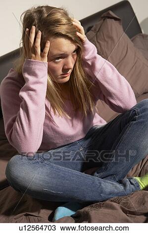 Depressed Teenage Girl Sitting In Bedroom At Home View Large Photo Image Stock Image - Depressed Teenage Girl Sitting In Bedroom At Home. Fotosearch