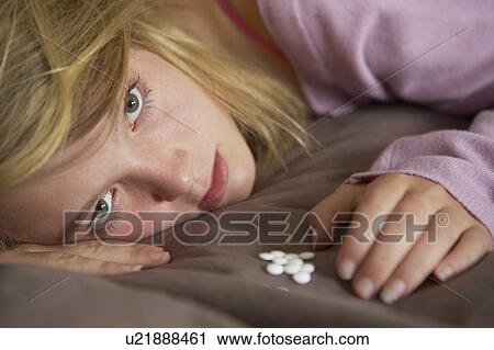 Depressed Teenage Girl Sitting In Bedroom With Pills View Large Photo Image Stock Image - Depressed Teenage Girl Sitting In Bedroom With Pills. Fotosearch