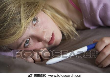 Depressed Teenage Girl Sitting In Bedroom With Pregnancy Test View Large Photo Image Stock Image - Depressed Teenage Girl Sitting In Bedroom With Pregnancy Test. Fotosearch