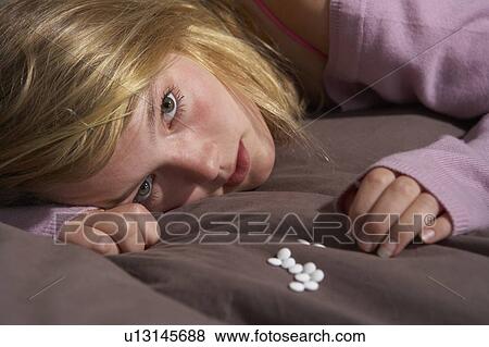 Depressed Teenage Girl Sitting In Bedroom With Pills View Large Photo Image Stock Photo - Depressed Teenage Girl Sitting In Bedroom With Pills. Fotosearch