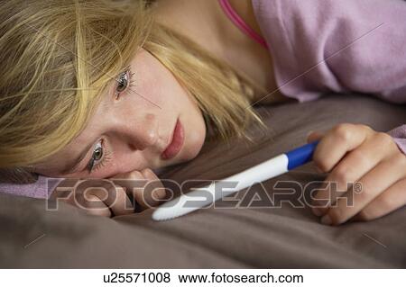 Depressed Teenage Girl Sitting In Bedroom With Pregnancy Test View Large Photo Image Stock Photo - Depressed Teenage Girl Sitting In Bedroom With Pregnancy Test. Fotosearch