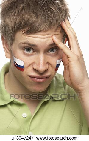 Stock Photo - Disappointed Young Male Sports Fan With Slovakian Flag Painted On Face. Fotosearch