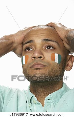 Disappointed Young Male Sports Fan With Ivory Coast Flag Painted On Face View Large Photo Image Stock Photo - Disappointed Young Male Sports Fan With Ivory Coast Flag Painted On Face. Fotosearch