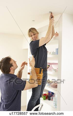 Electrician Teaching Apprentice To Install Light Fitting In Home View Large Photo Image Stock Photo - Electrician Teaching Apprentice To Install Light Fitting In Home. Fotosearch