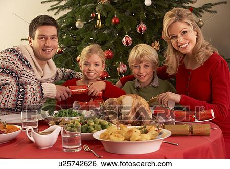 Family Enjoying Christmas Meal At Home View Large Photo Image Stock Photograph - Family Enjoying Christmas Meal At Home. Fotosearch