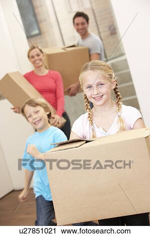 Family happy on moving day carrying cardboard boxes View Large Photo Image Stock Image - Family happy on moving day carrying cardboard boxes. Fotosearch