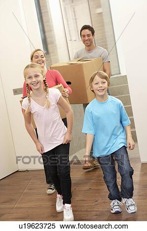Family happy on moving day carrying cardboard boxes View Large Photo Image Stock Photography - Family happy on moving day carrying cardboard boxes. Fotosearch
