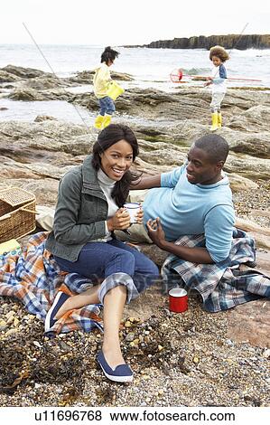 Stock Photo - Family having picnic. Fotosearch
