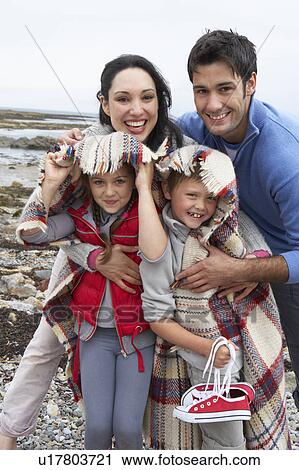 Stock Image - Family on beach with blankets. Fotosearch