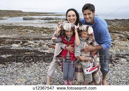 Family on beach with blankets View Large Photo Image Stock Photo - Family on beach with blankets. Fotosearch