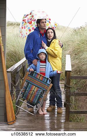 Family on beach with umbrella View Large Photo Image Stock Image - Family on beach with umbrella. Fotosearch