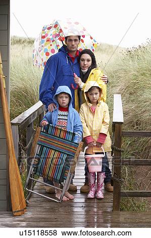 Family on beach with umbrella View Large Photo Image Stock Photo - Family on beach with umbrella. Fotosearch