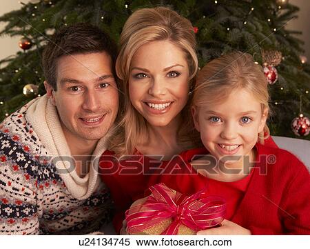 Stock Photography - Family Opening Christmas Gifts At Home. Fotosearch
